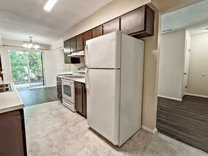 Efficient kitchen with ample cabinet storage and clear sightlines into the dining area and hallway—making everyday routines feel organized and connected.