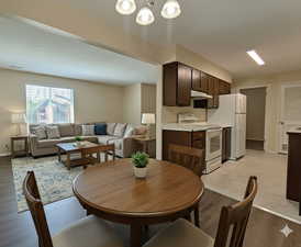 Dining room featuring light wood-style floors and a chandelier