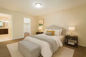 Bedroom featuring carpet and a spacious closet