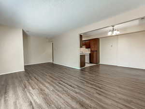 Large open living space with durable flooring and efficient flow to the kitchen, supporting low-maintenance, long-term rental use.