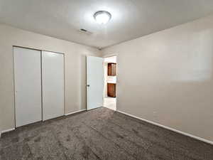 Updated second bedroom with new carpet and paint, providing a versatile space that supports rental flexibility.