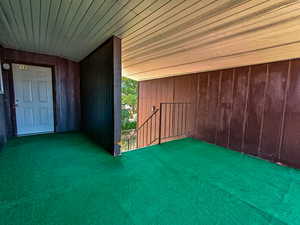 Covered exterior walkway leading to the unit entrance, providing protected access and a functional transition from outdoors to indoors.