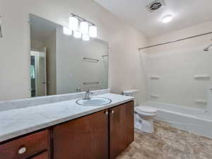 Spacious full bathroom featuring a long vanity countertop and tub/shower combo, offering above-average size for an apartment-style unit.
