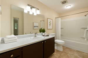 Bathroom with vanity, shower / bath combination with curtain, and light tile patterned flooring