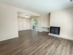 Open living area with durable flooring, fireplace, and direct access to dining and balcony—functional layout that supports long-term rental demand.