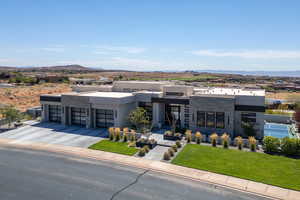 Contemporary home featuring stone siding, a mountain view, a garage, and stucco siding