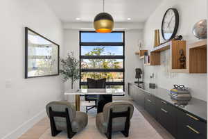 Home office featuring light wood-style floors and baseboards