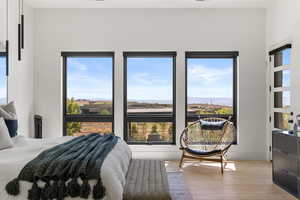 Bedroom featuring light wood finished floors and a mountain view