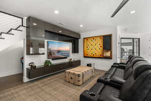 Living room featuring stairs and recessed lighting