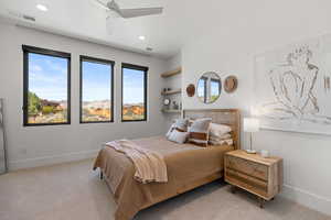 Bedroom with light carpet, ceiling fan, and recessed lighting