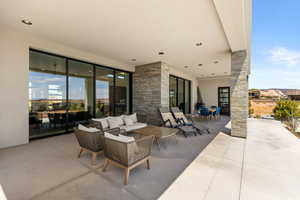 View of patio with an outdoor hangout area