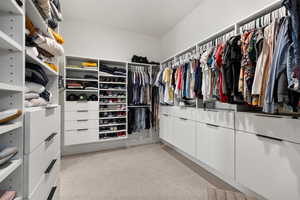 Spacious closet with light colored carpet