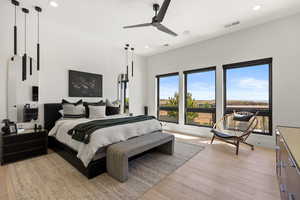 Bedroom featuring light wood-style flooring, a ceiling fan, and recessed lighting