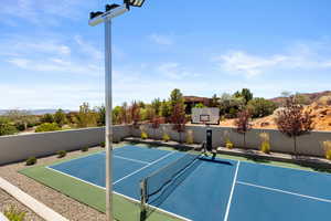 View of basketball court with a tennis court and a mountain view