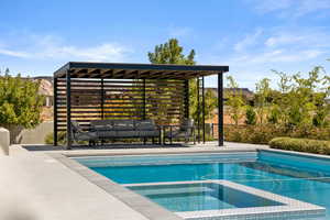View of pool with a mountain view, a patio area, and a pool with connected hot tub
