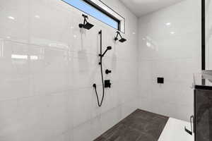 Full bath with a marble finish shower
