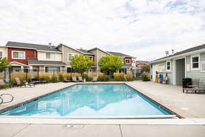 Community pool featuring a patio and a residential view