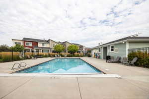 Community pool with a patio