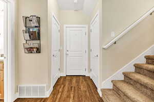 Foyer entrance featuring dark wood-style flooring and stairway