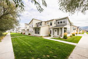 View of front of home featuring a residential view, a front lawn, and a porch