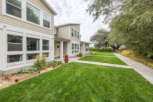 View of front of home featuring a front yard and a garden