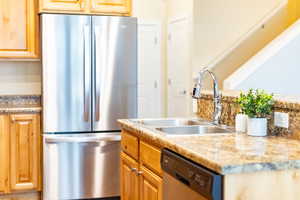 Kitchen with appliances with stainless steel finishes and a sink