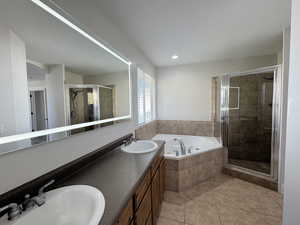 Primary en-suite bathroom with double vanity, shower and large bathtub