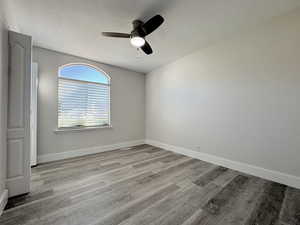 Unfurnished bedroom with a ceiling fan and light wood-style flooring