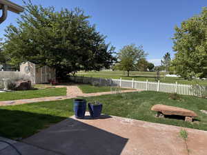 View of yard with a storage shed and a patio area