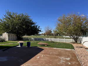 View of fenced yard and gate to golf course