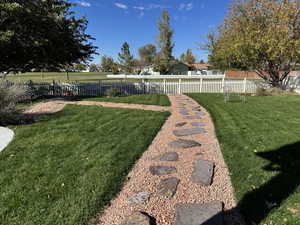 View of fenced yard and gate to golf course