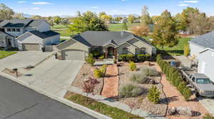 Ranch-style home featuring an attached garage, concrete driveway, stucco siding, and a residential view
