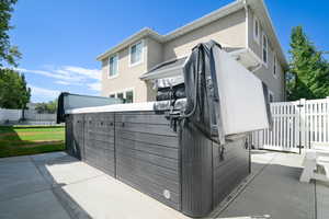 View of side of property featuring stucco siding and a patio