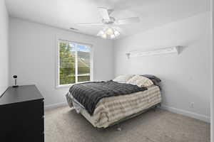 Carpeted bedroom featuring baseboards and ceiling fan
