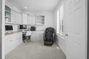 Office featuring built in study area, light colored carpet, and recessed lighting