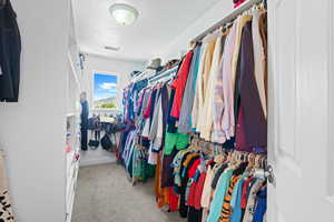 Spacious closet with light colored carpet