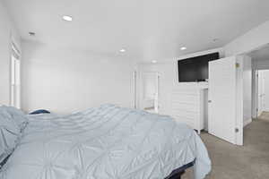 Bedroom with light colored carpet and recessed lighting