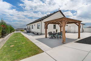 Back of property featuring a gazebo, a patio, stucco siding, and a mountain view