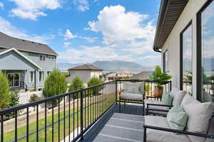 Balcony featuring a residential view and a mountain view