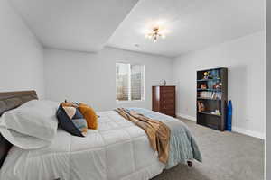 Bedroom with carpet floors and a textured ceiling