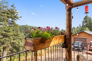 Balcony featuring a wooded view