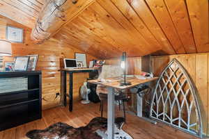 Office featuring lofted ceiling, light wood finished floors, wooden walls, and wooden ceiling