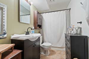Full bathroom with vanity, shower / tub combo, and light tile patterned floors