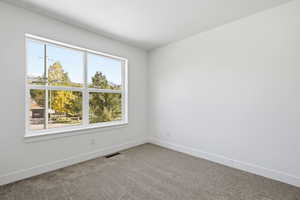 Spare room with carpet flooring and baseboards