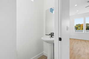 Bathroom with light wood finished floors and recessed lighting