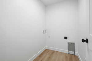 Laundry room featuring light wood finished floors, washer hookup, and electric dryer hookup