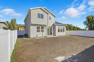 Rear view of property featuring a fenced backyard