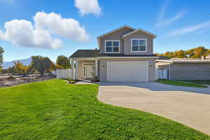 Traditional-style house featuring driveway and a garage