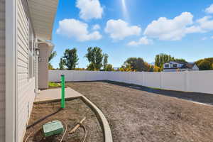 Fenced backyard with a patio