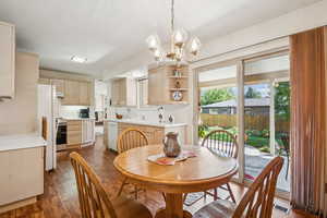 Dining room featuring dark wood-type flooring and a chandelier
